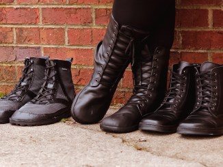 3 pairs of barefoot combat boots in front of wall